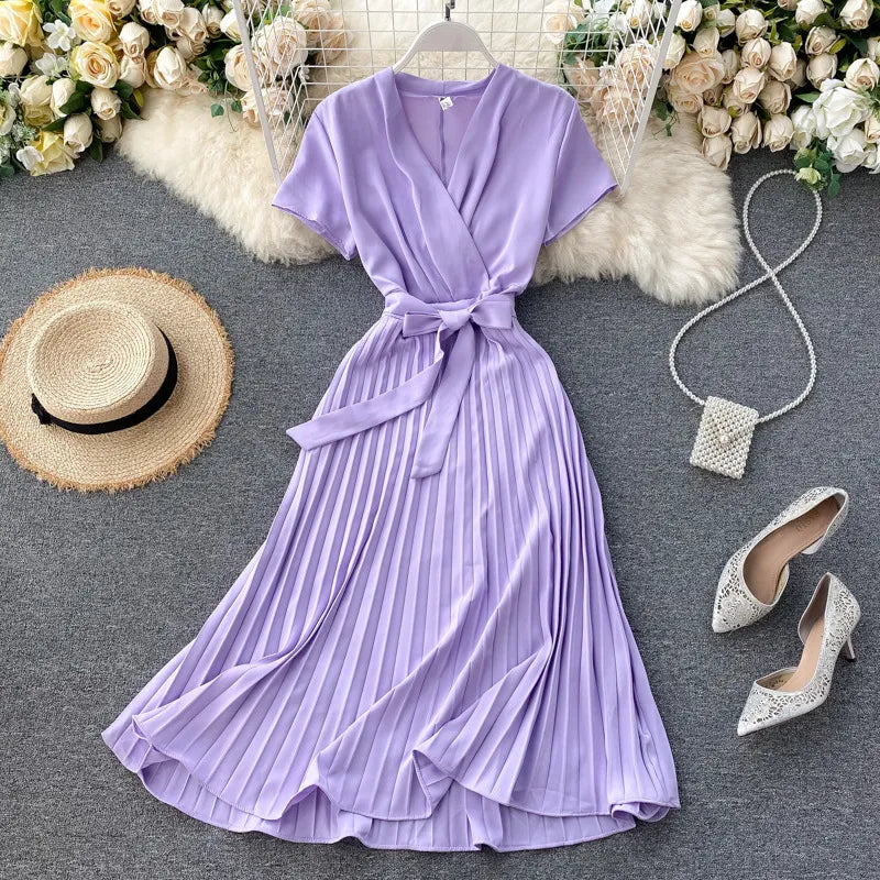 Robe plissée longueur genou à taille haute et encolure en V dans une couleur unie élégante
