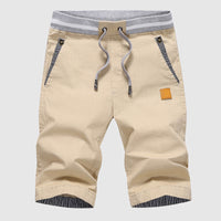 Shorts décontractés pour hommes avec cordon à la taille, poches zippées et coupe ample jusqu'au genou