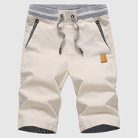 Shorts décontractés pour hommes avec cordon à la taille, poches zippées et coupe ample jusqu'au genou