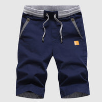 Shorts décontractés pour hommes avec cordon à la taille, poches zippées et coupe ample jusqu'au genou