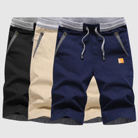 Shorts décontractés pour hommes avec cordon à la taille, poches zippées et coupe ample jusqu'au genou