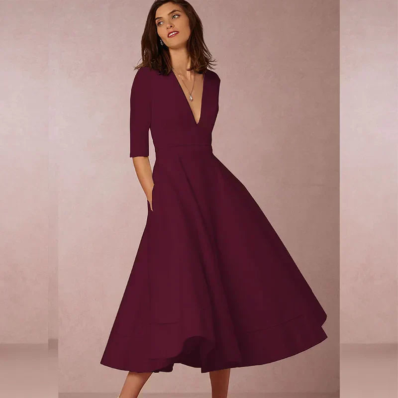 Robe midi élégante avec décolleté en V et jupe volumineuse pour un look élégant.