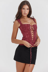 Élégant top corset à lacets pour femme, de couleur merlot, pour un look sophistiqué.